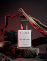 Eau de parfum bottle on dark base, black cap, clear glass