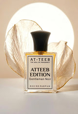 AT-TEEB Edition eau de parfum, clear bottle with black cap and 'Gentleman Noir' label.