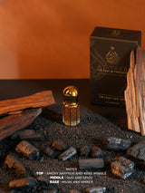 AMEER-AL-OUDH fragrance oil bottle on dark stones with tall wooden stick and box