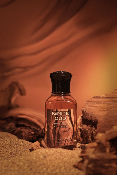 IGNITE OUD perfume bottle, black cap and amber bottle, label centered.