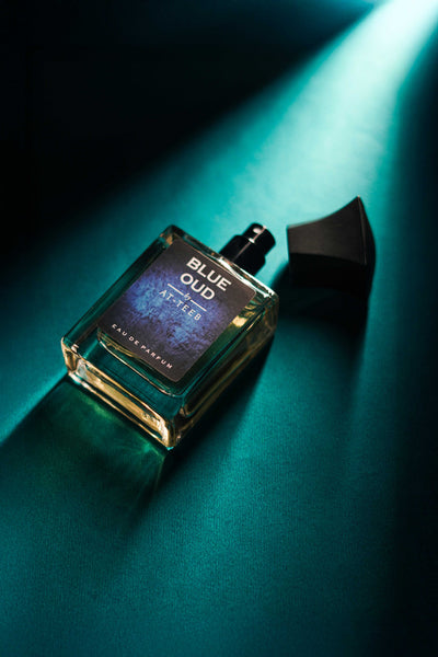 Blue Oud perfume bottle with rectangular glass body and black cap