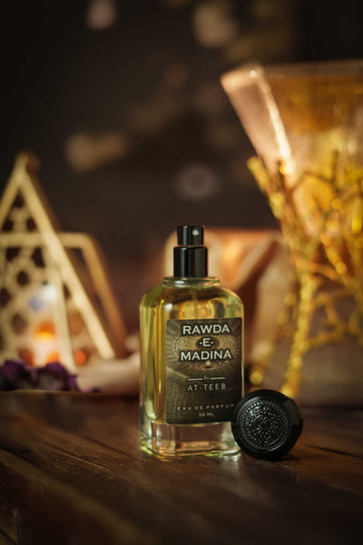 RAWDA-E-MADINA perfume bottle with black cap and matching spray top, amber glass