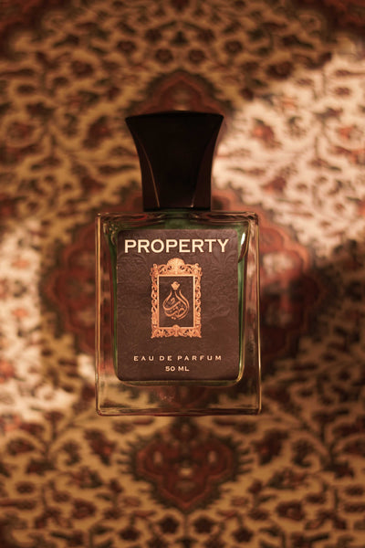 Property eau de parfum bottle with black cap, clear glass, 50 ml text label
