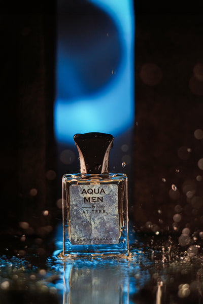 AQUA MEN men's fragrance bottle with blue liquid and bokeh droplets