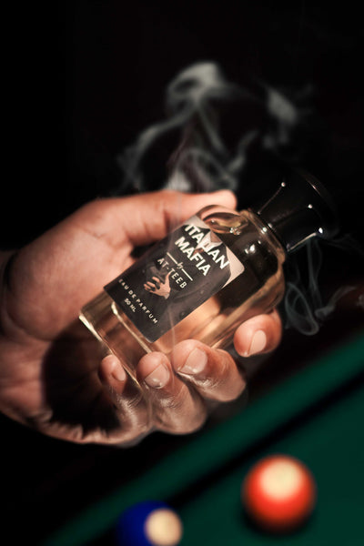 Eau de parfum bottle 60 ml in hand, smoky black glass with gold ITALIAN MAFIA label