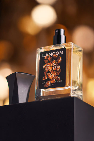 Lancom parfum bottle with clear glass, dark label, and silver cap
