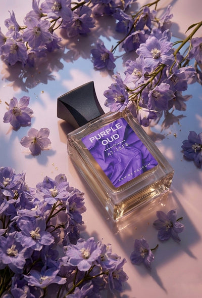 Perfume bottle tilted in clear glass with dark cap and purple label