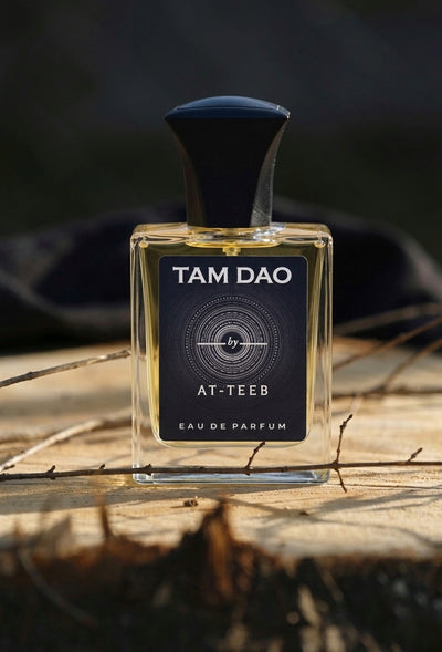 Eau de parfum bottle with dark navy cap and clear glass, label facing front