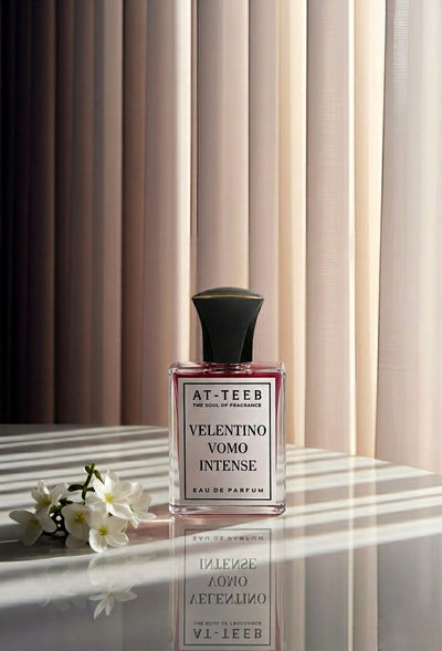Eau de parfum spray bottle with dark cap and VOMO INTENSE label, glass